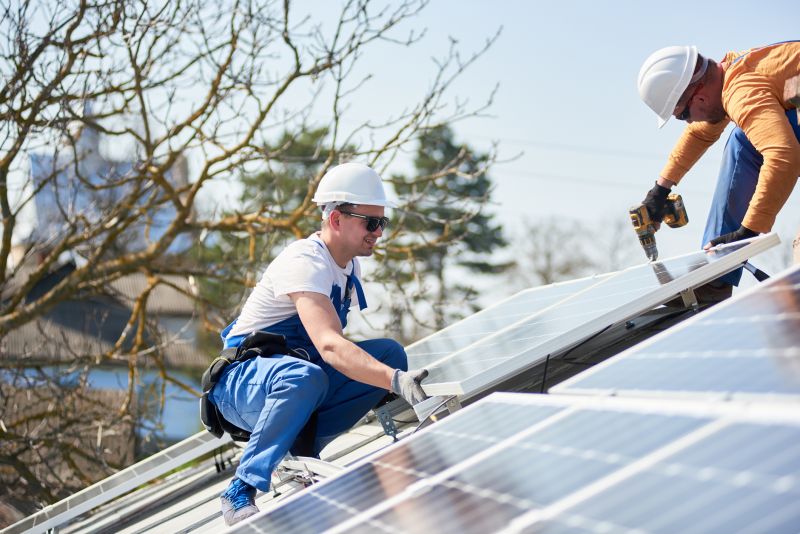 Technician Securing Solar Panels